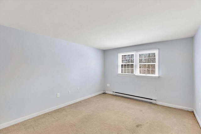 carpeted empty room featuring a baseboard radiator