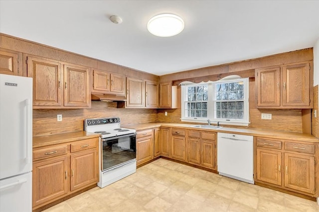 kitchen featuring white appliances and sink