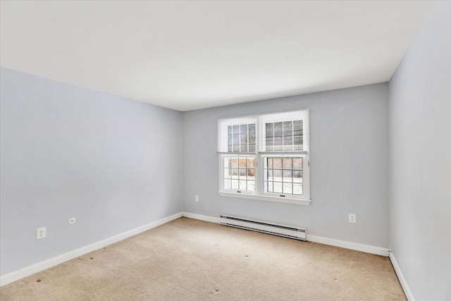 unfurnished room featuring a baseboard heating unit and light colored carpet