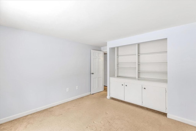 unfurnished bedroom with a closet and light colored carpet