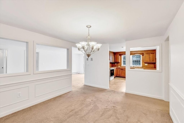 unfurnished dining area featuring a notable chandelier and light carpet