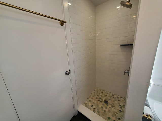 bathroom with tiled shower