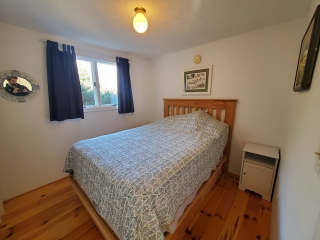 bedroom with wood-type flooring