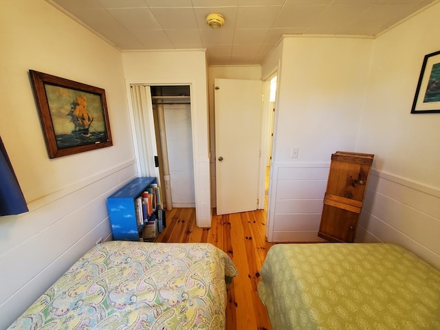 bedroom featuring wood-type flooring and a closet