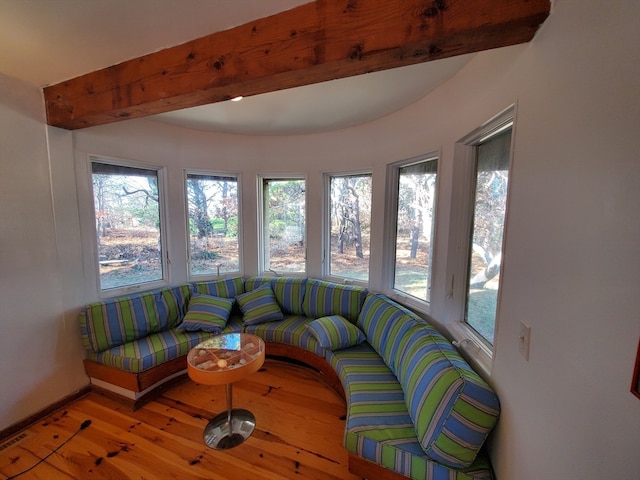 sunroom / solarium featuring beam ceiling