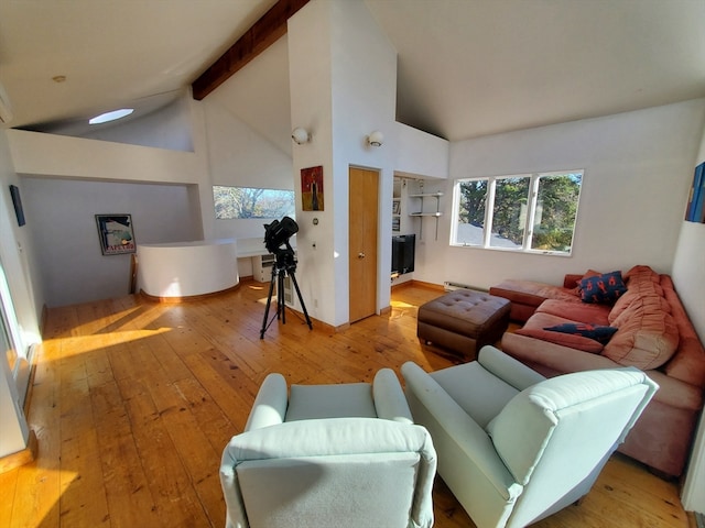 living room with high vaulted ceiling, light hardwood / wood-style floors, beam ceiling, and a wealth of natural light