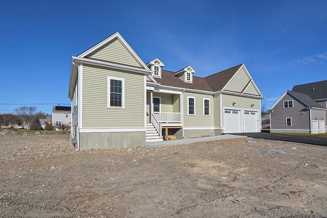 view of front of house featuring a garage and a porch