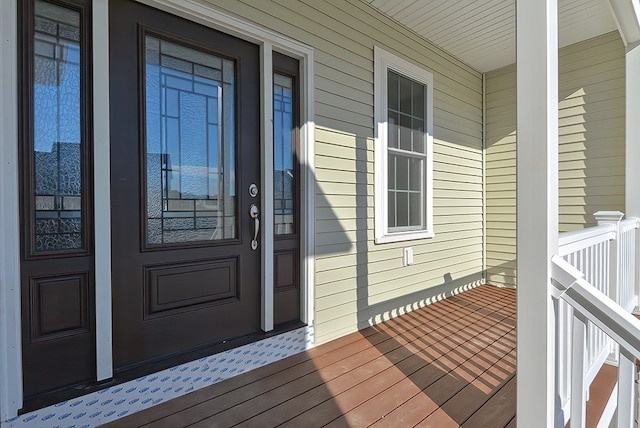 view of exterior entry featuring covered porch