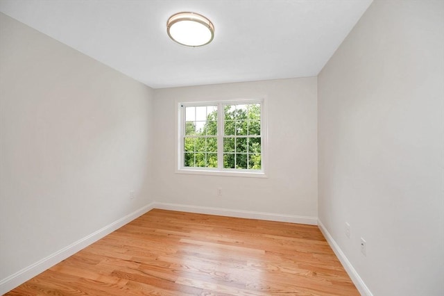 spare room with light hardwood / wood-style flooring