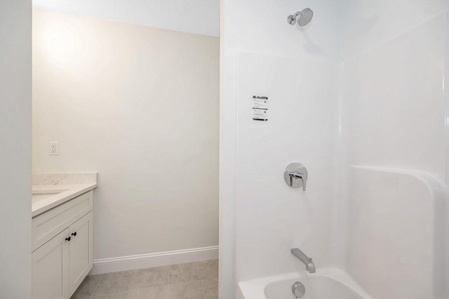 bathroom featuring tile patterned floors, vanity, and bathing tub / shower combination