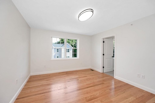 spare room with light wood-type flooring