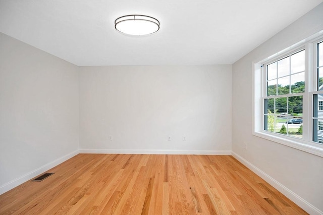 unfurnished room with light wood-type flooring