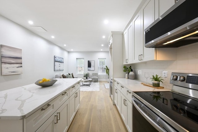 kitchen featuring stainless steel appliances, light wood-type flooring, and white cabinets