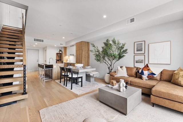 living room with light hardwood / wood-style flooring