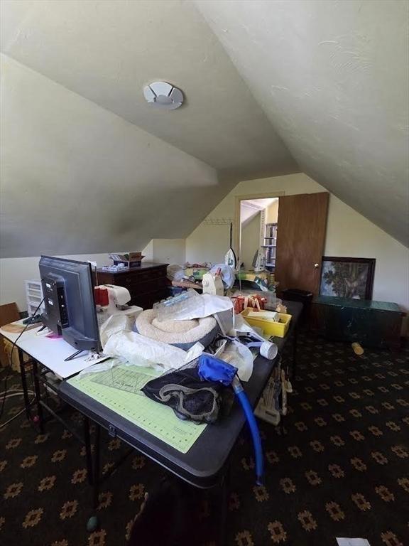 interior space with carpet flooring and lofted ceiling