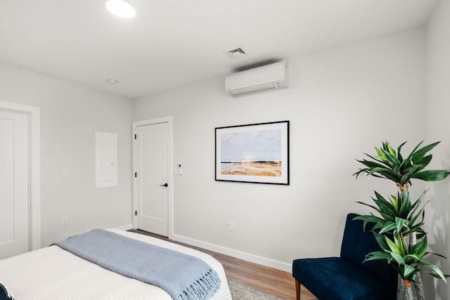 10 Somerset Unit 201, Winthrop, MA 02152 - bedroom with a wall unit AC and wood finished floors