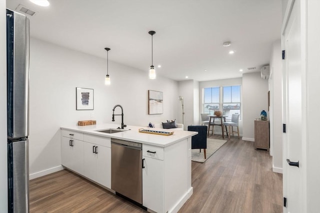 10 Somerset Unit 201, Winthrop, MA 02152 - kitchen with appliances with stainless steel finishes, a peninsula, light wood-style flooring, white cabinets, and light countertops