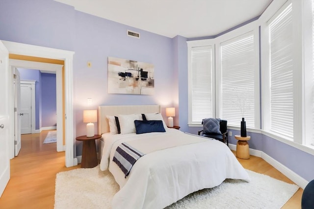 bedroom featuring light wood-type flooring and baseboards