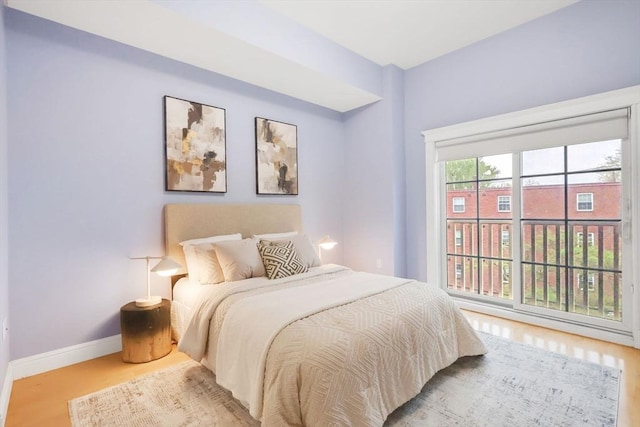 bedroom featuring baseboards and wood finished floors