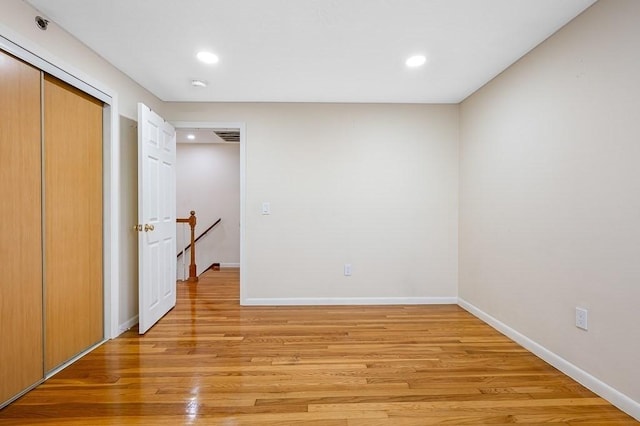 unfurnished bedroom featuring a closet and light hardwood / wood-style floors