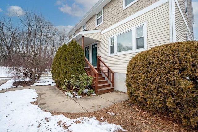 view of snow covered property entrance