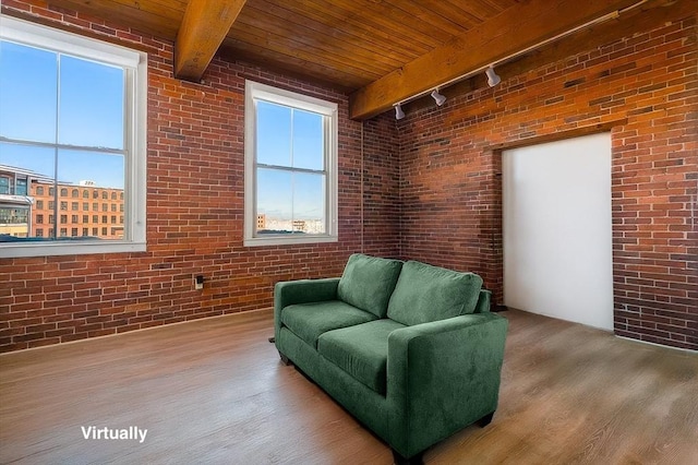 21 Wingate Unit 606, Haverhill, MA 01832 - sitting room featuring track lighting, a wood ceiling with exposed beams, wood finished floors, brick wall, and healthy amount of natural light
