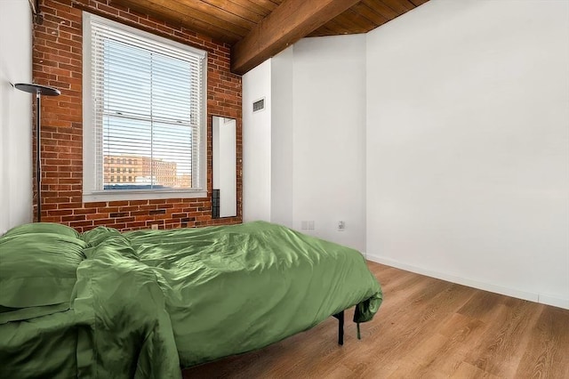 21 Wingate Unit 606, Haverhill, MA 01832 - bedroom featuring a wood ceiling with exposed beams, wood finished floors, and brick wall
