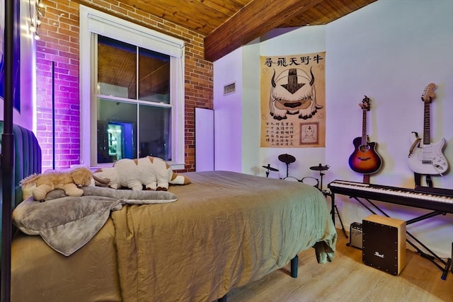 21 Wingate Unit 606, Haverhill, MA 01832 - bedroom with brick wall, wood finished floors, and wooden ceiling