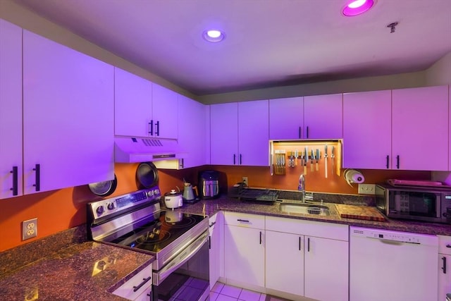 21 Wingate Unit 606, Haverhill, MA 01832 - kitchen featuring white dishwasher, stainless steel electric stove, red cabinets, exhaust hood, and dark countertops
