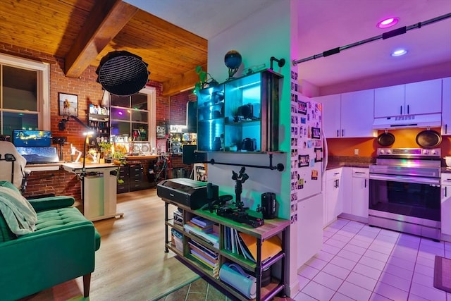 21 Wingate Unit 606, Haverhill, MA 01832 - kitchen with stainless steel range with electric stovetop, under cabinet range hood, a wooden ceiling with exposed beams, tile patterned flooring, and recessed lighting