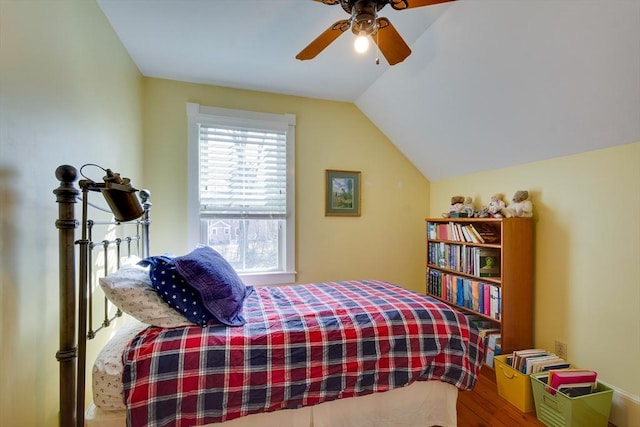 bedroom featuring lofted ceiling, wood finished floors, and a ceiling fan