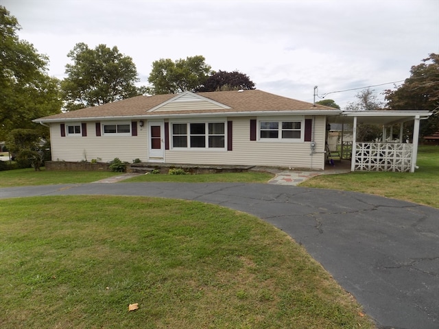 ranch-style house with a front lawn and a carport