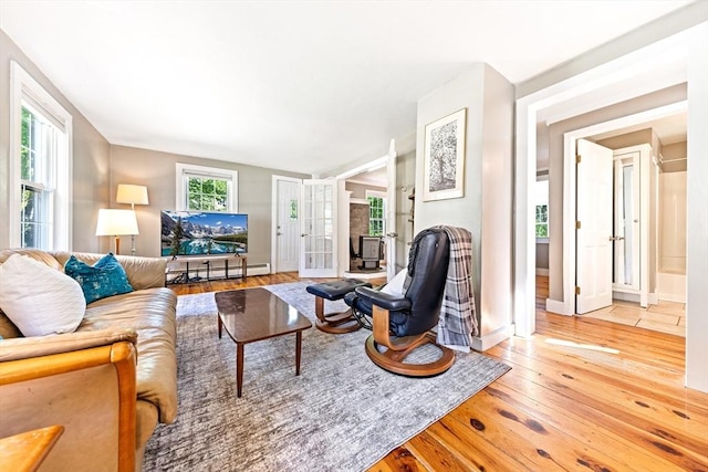 17 S High St, Ashburnham, MA 01430 - living area with wood-type flooring, a baseboard radiator, baseboards, and french doors