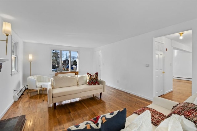 living room featuring hardwood / wood-style flooring and a baseboard heating unit