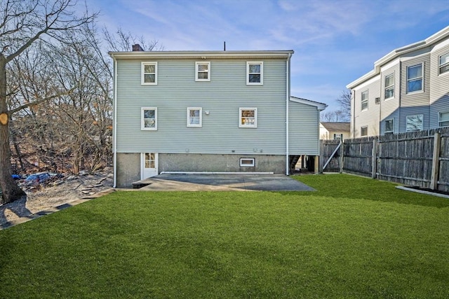 back of property with a patio and a lawn