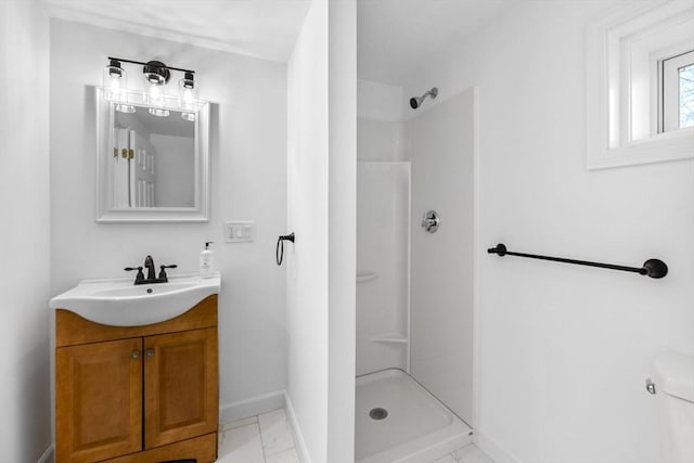 bathroom featuring vanity, toilet, and walk in shower