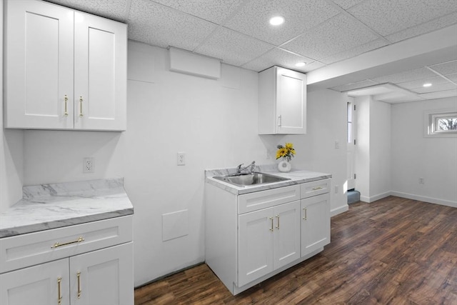 kitchen with white cabinetry, sink, a drop ceiling, and dark hardwood / wood-style floors