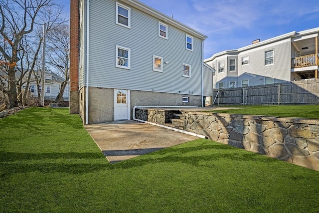 rear view of property featuring a yard and a patio