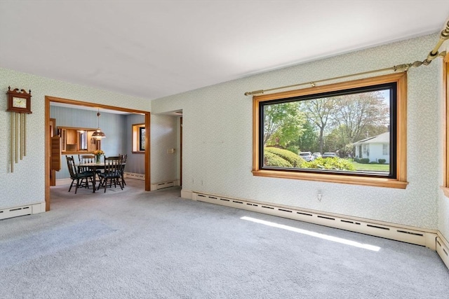 living area with carpet flooring, a baseboard radiator, and wallpapered walls