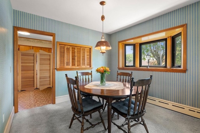 carpeted dining room with wallpapered walls, baseboard heating, and baseboards