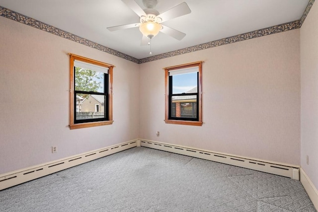 empty room with carpet floors, ceiling fan, and baseboards