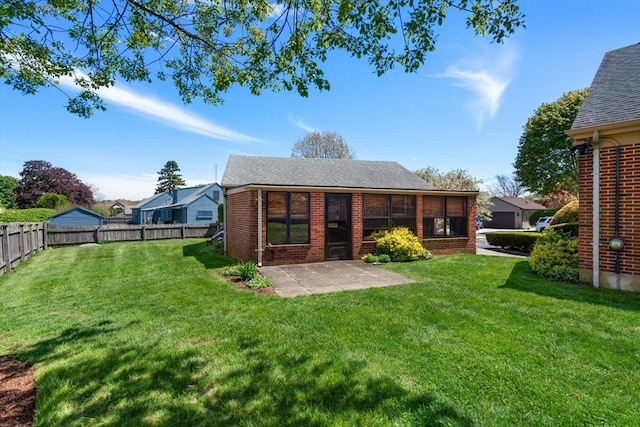 back of property with a patio, brick siding, and a shingled roof