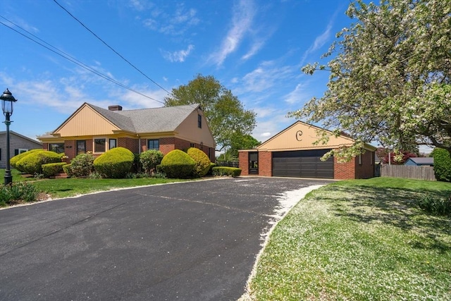 single story home featuring brick siding, driveway, and a garage
