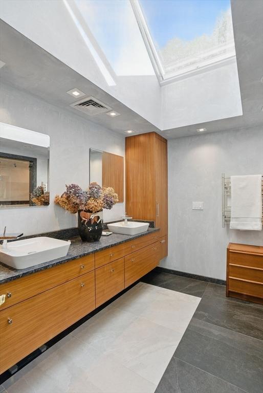 12 Vose Hill Rd, Westford, MA 01886 - bathroom featuring double vanity, baseboards, and a high ceiling