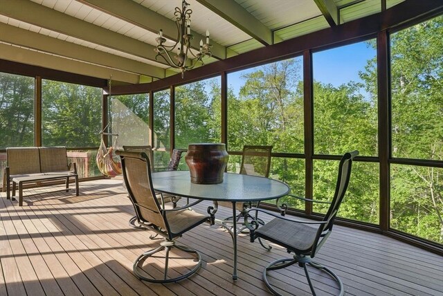 12 Vose Hill Rd, Westford, MA 01886 - sunroom with beamed ceiling, outdoor dining area, a chandelier, and view of wooded area