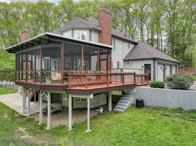 12 Vose Hill Rd, Westford, MA 01886 - rear view of property with a sunroom, a chimney, a wooden deck, stairway, and a lawn