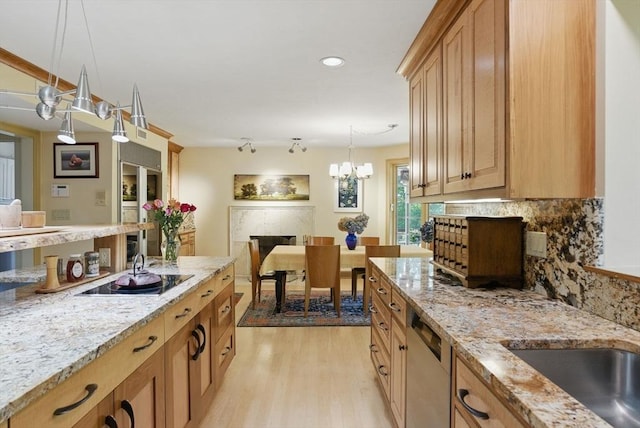 12 Vose Hill Rd, Westford, MA 01886 - kitchen with dishwasher, light wood-style flooring, backsplash, black electric stovetop, and light stone countertops