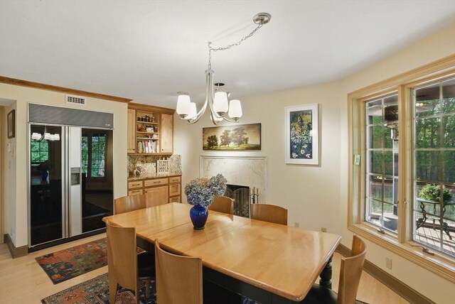 12 Vose Hill Rd, Westford, MA 01886 - dining area with healthy amount of natural light, a chandelier, light wood finished floors, and baseboards