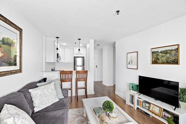 133 Commander Shea Blvd Unit 713, Quincy, MA 02171 - living room with wood finished floors, a textured ceiling, recessed lighting, and baseboards