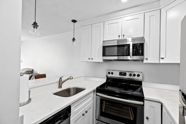 133 Commander Shea Blvd Unit 713, Quincy, MA 02171 - kitchen featuring stainless steel appliances, a sink, a textured ceiling, white cabinets, and hanging light fixtures